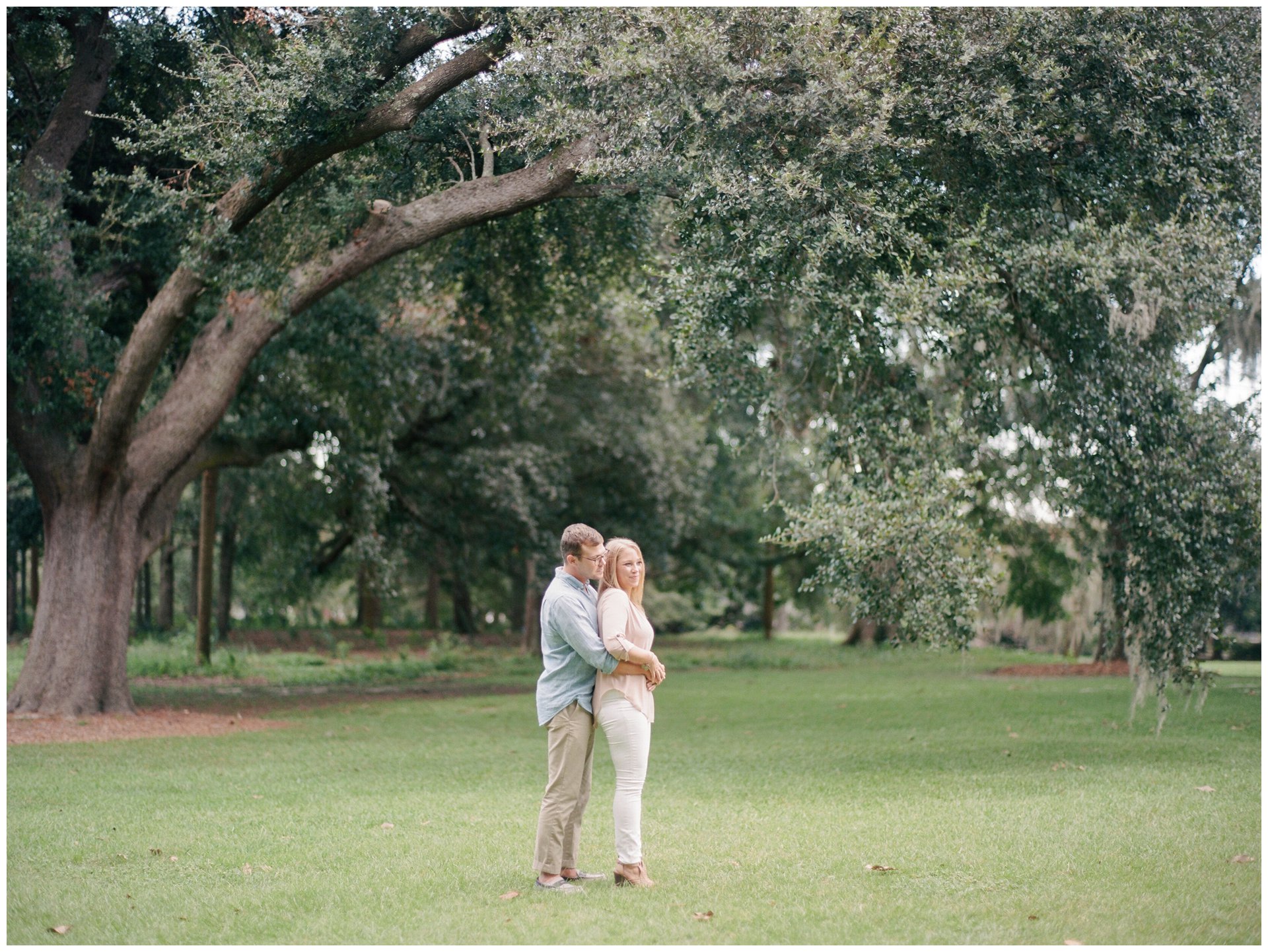 Engaged couple under oak tree in Hampton Park